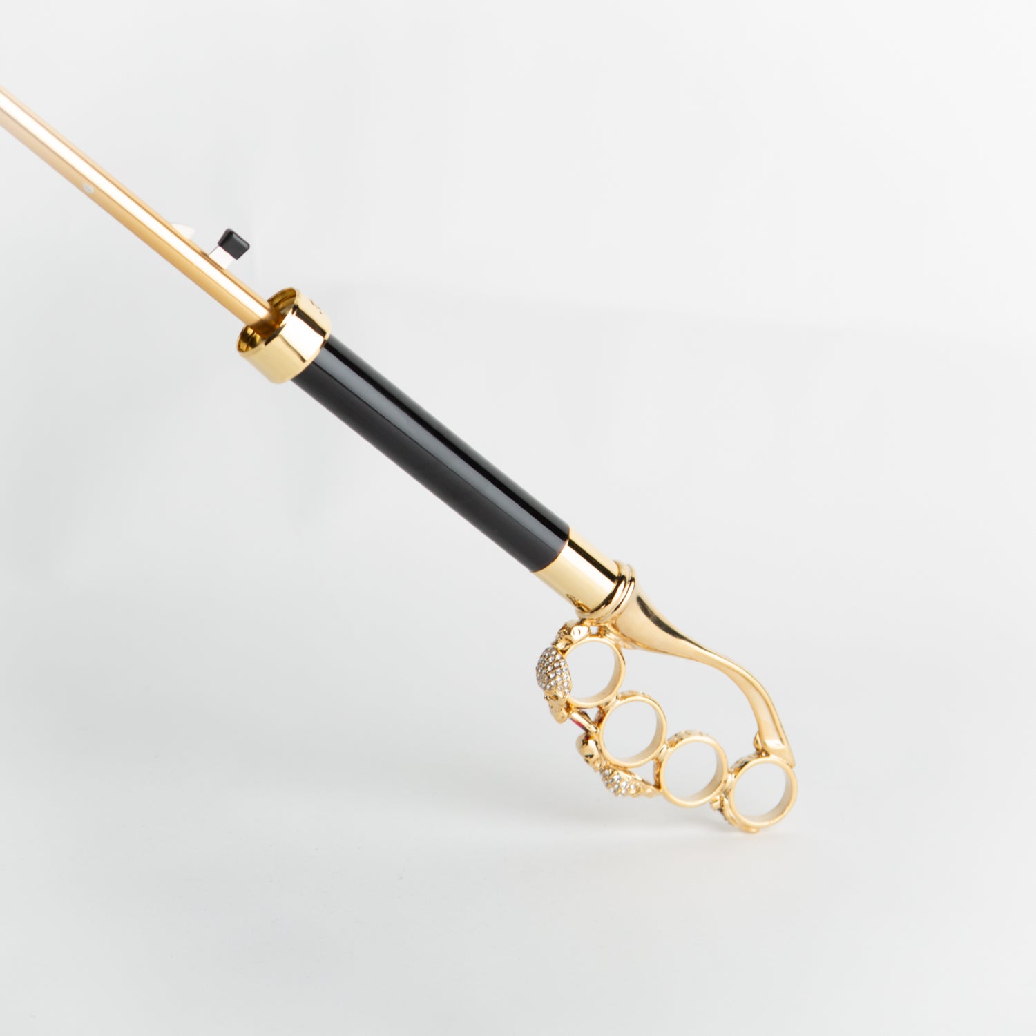 black umbrella with golden skull knuckleduster handle