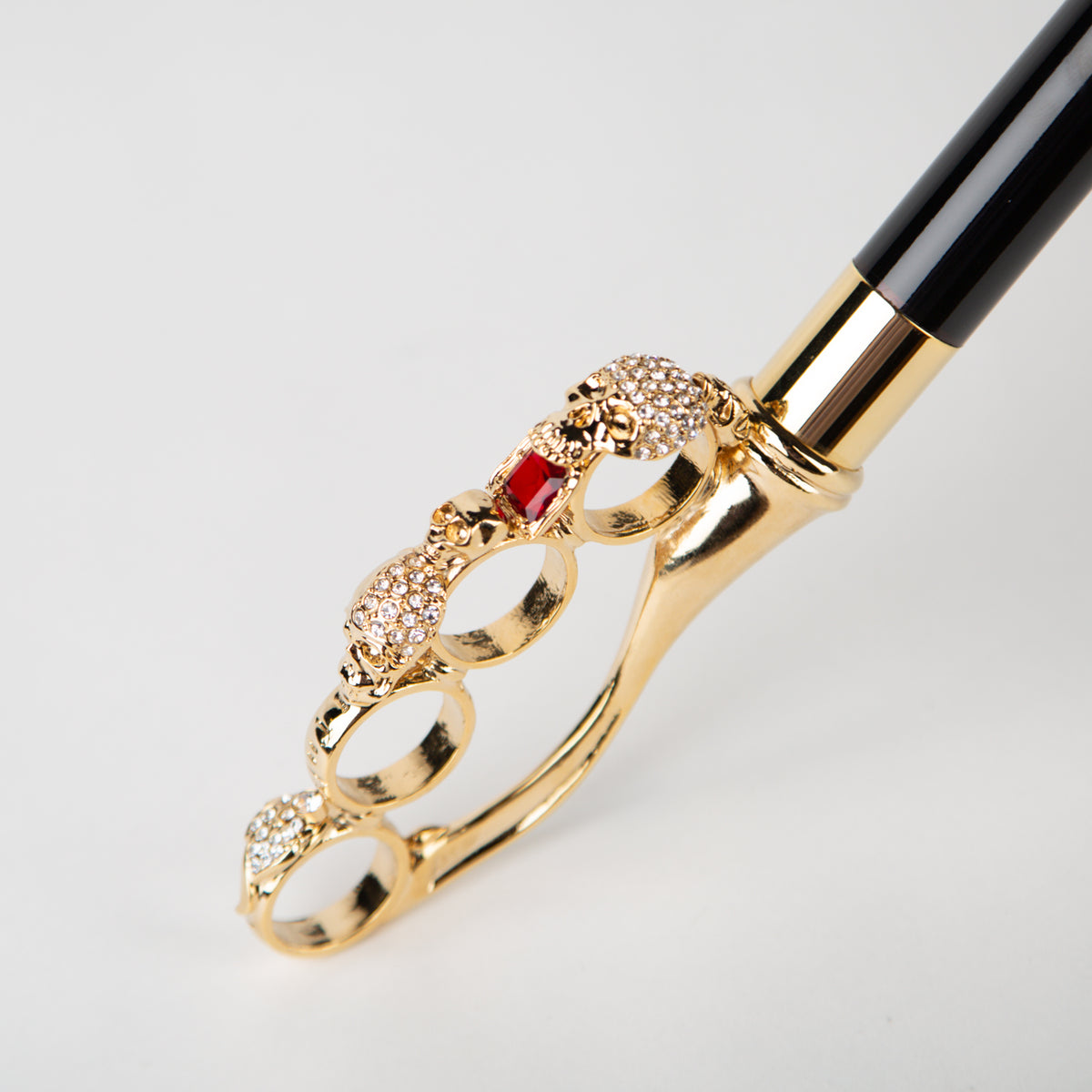 black umbrella with golden skull knuckleduster handle